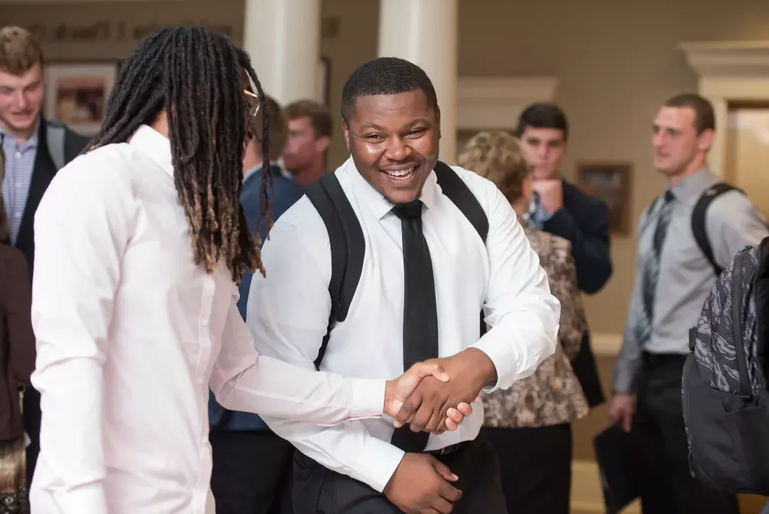 Students shaking hands at COBE Career Day