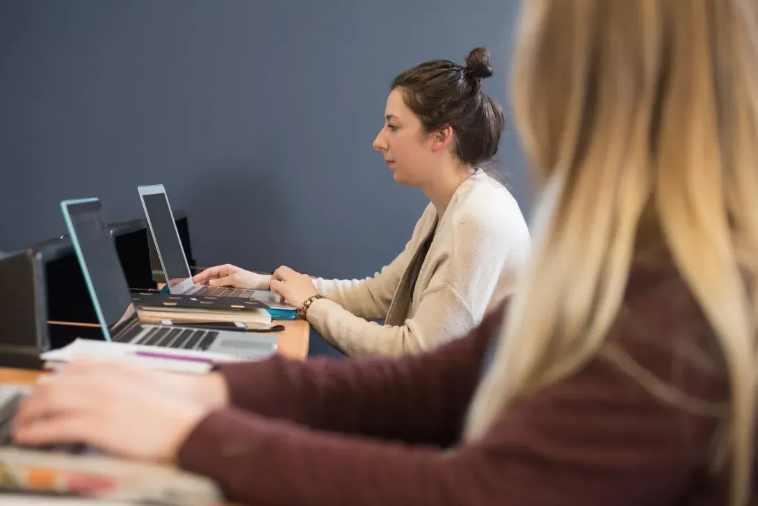 Business Management student in classroom working on a computer