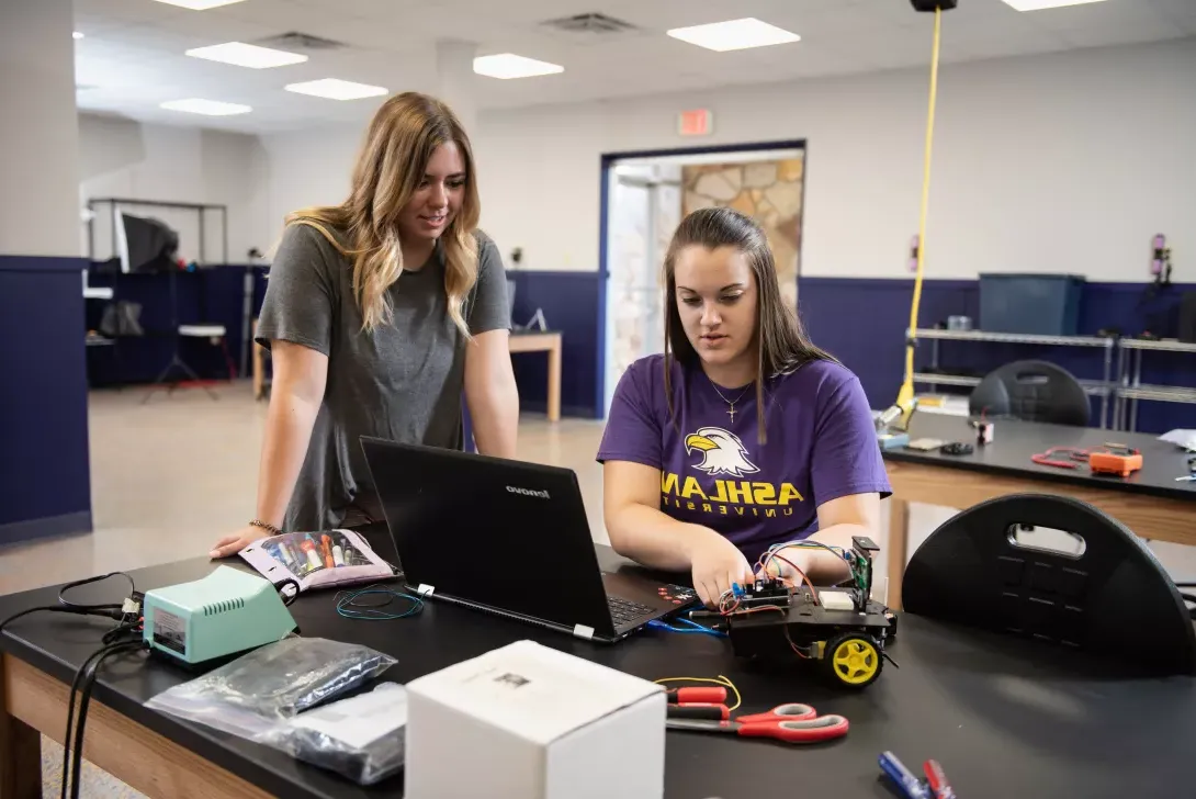 Eagle Consulting Group members preparing a robot kit